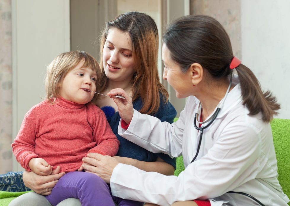 Mature children's Doctor checking baby's temperature